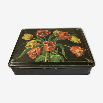 Tin box decorated with flowers on a black background
