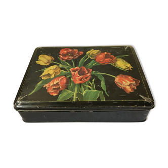Tin box decorated with flowers on a black background