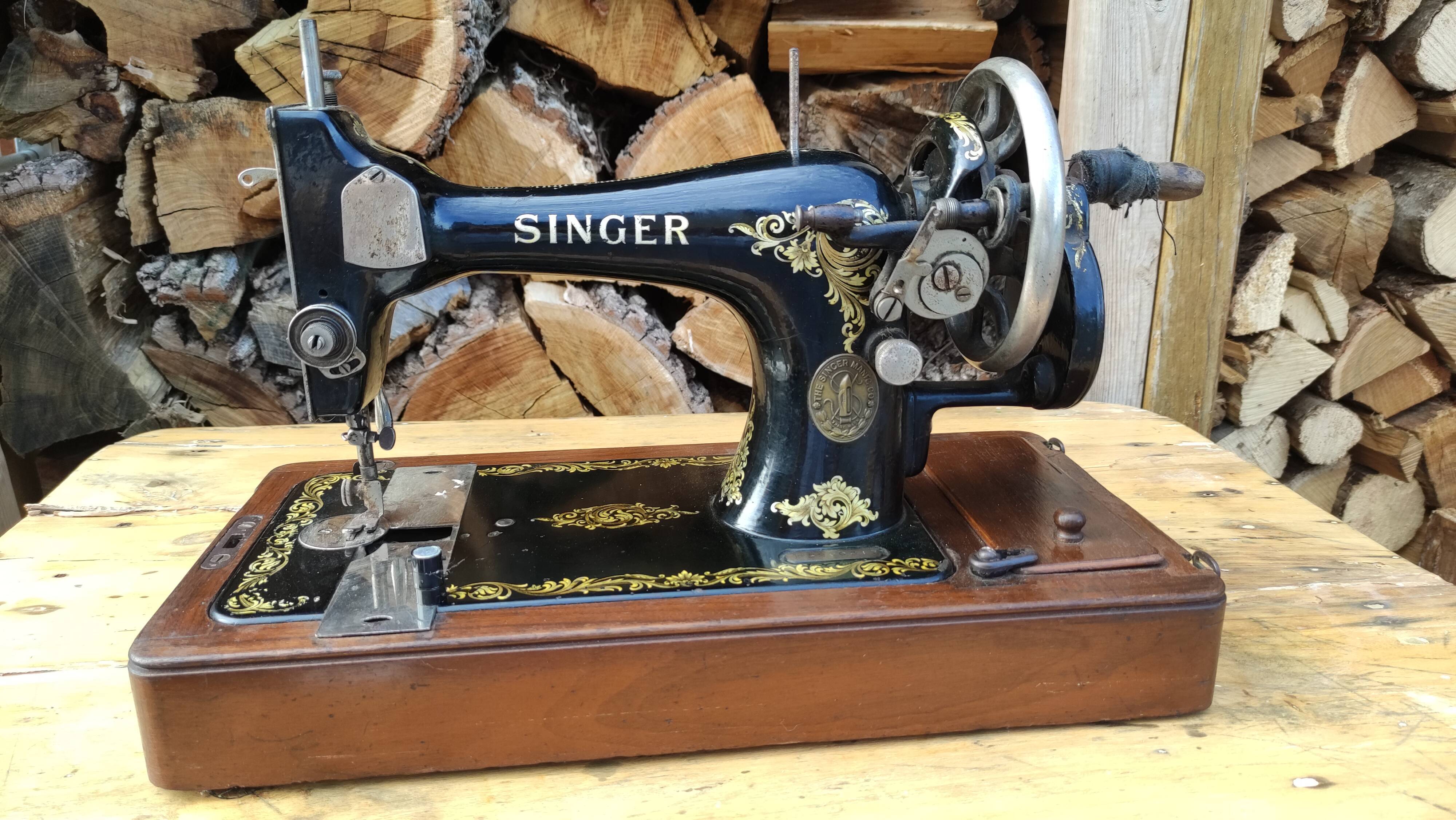 Old Singer sewing machine on its original base