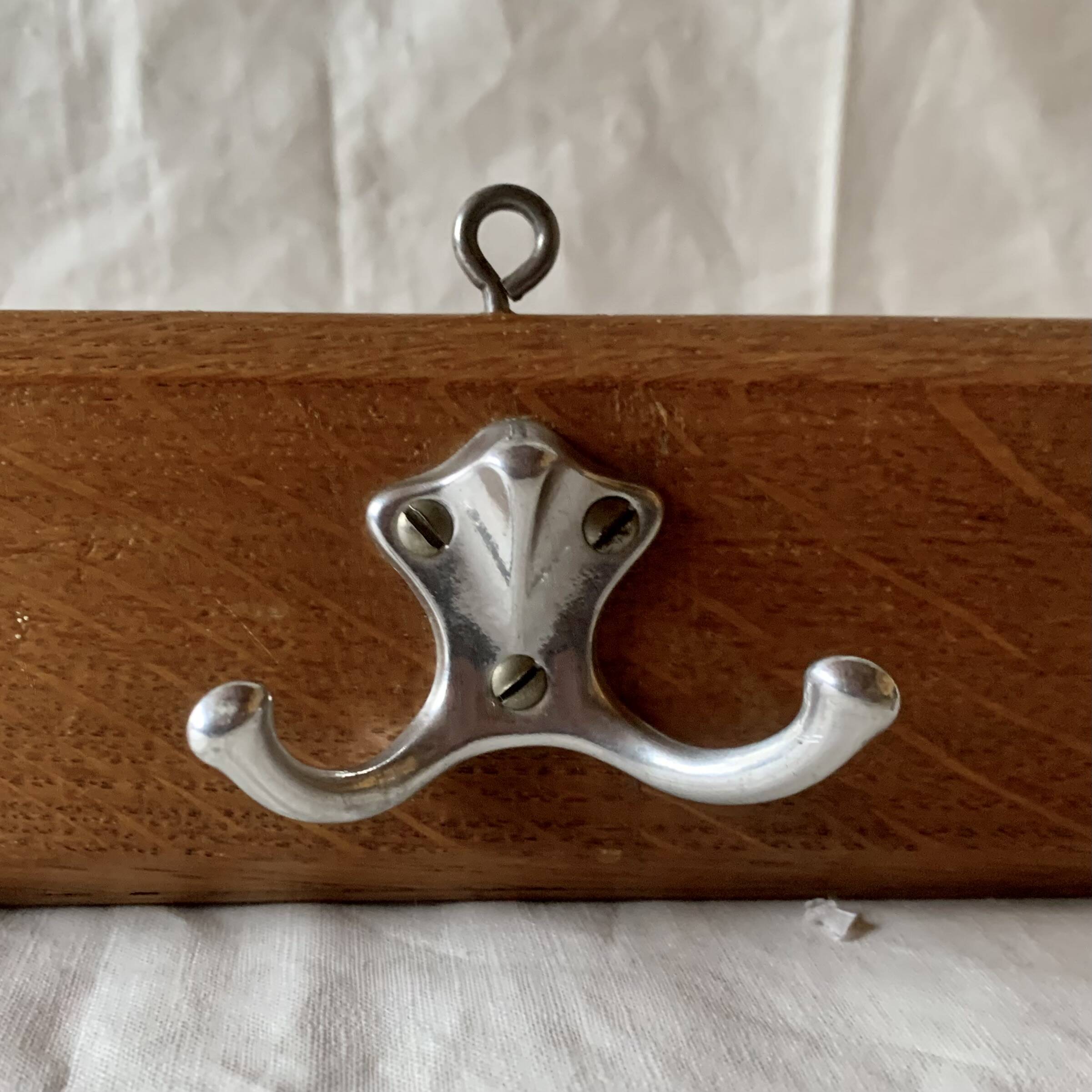 Vintage wooden wall-mounted coat rack with three double hooks