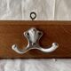 Vintage wooden wall-mounted coat rack with three double hooks