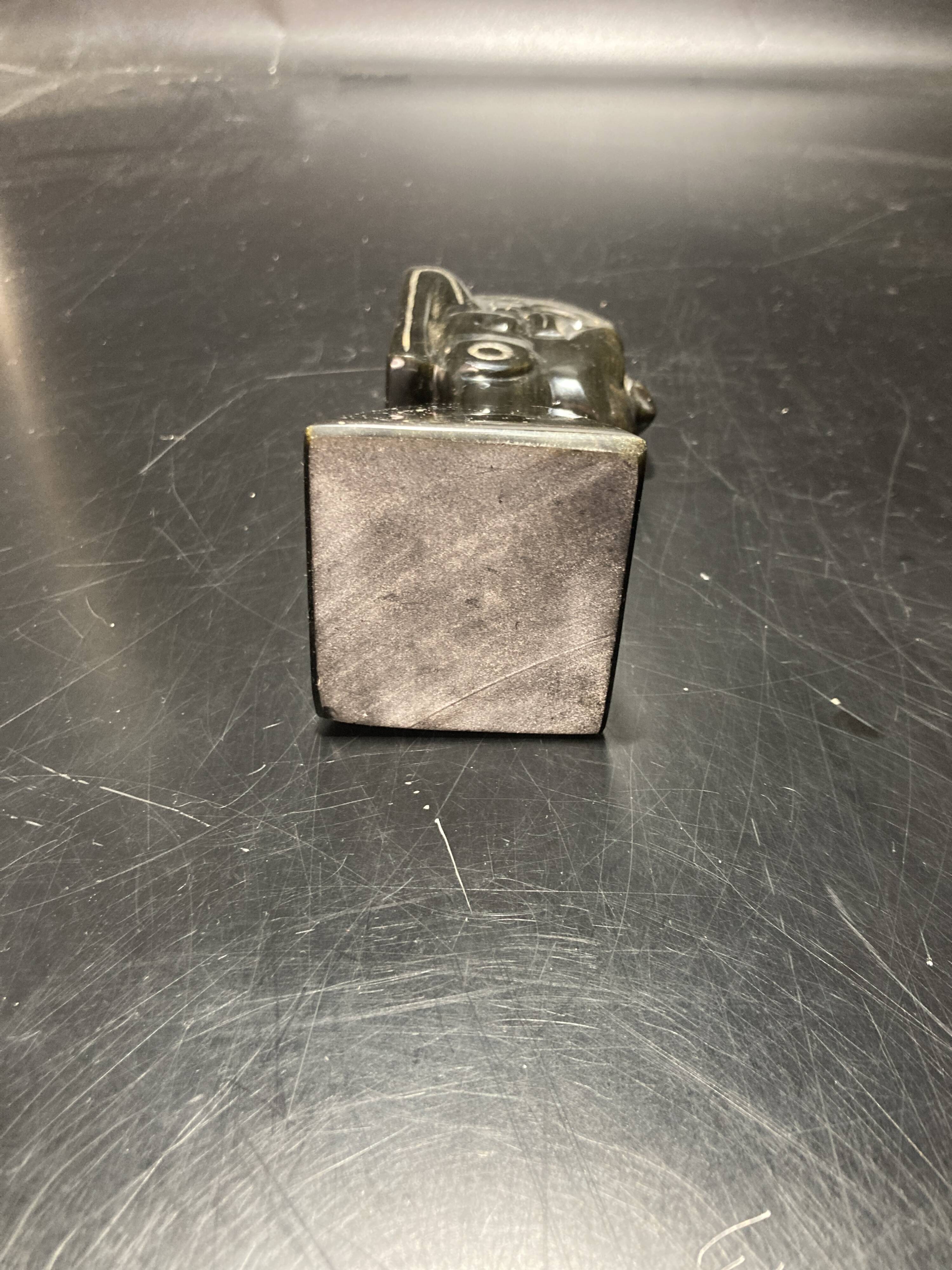 Ceramic sculpture representing a woman's face placed on a black base