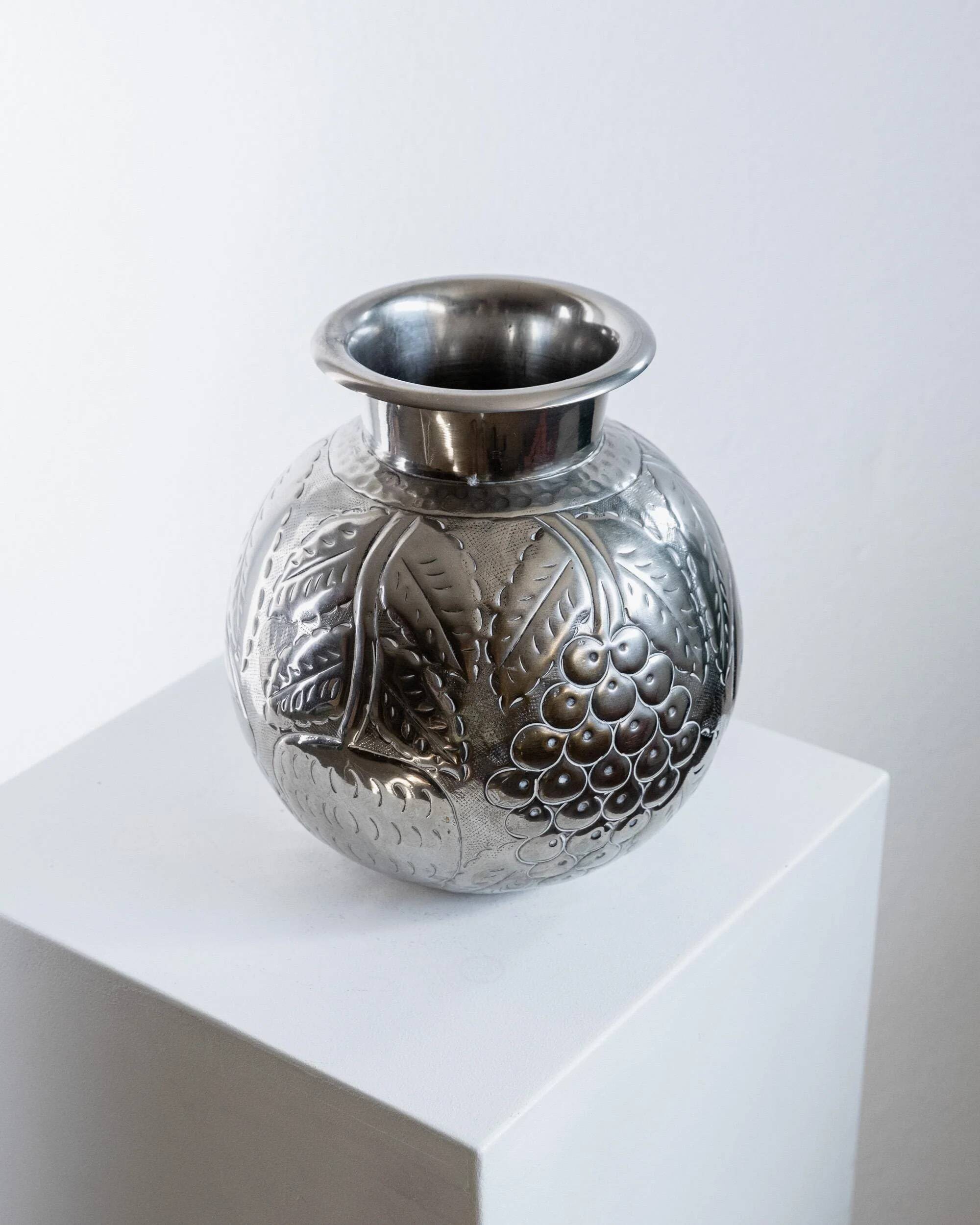 Vintage Italian vase in nickel-plated brass from the 1960s, hand-hammered relief of fruits and leaves.