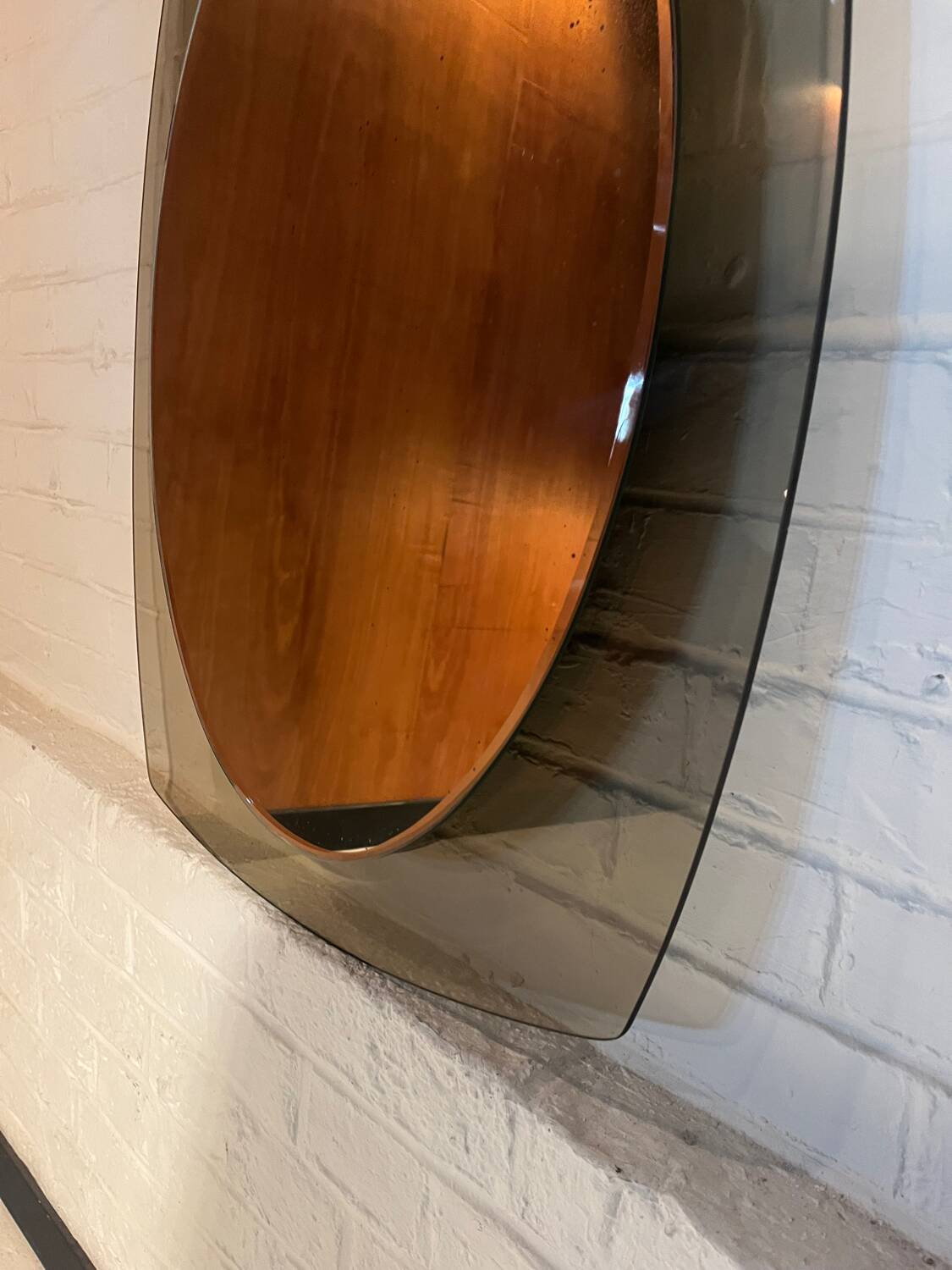 Vintage smoked glass mirror from around 1970.