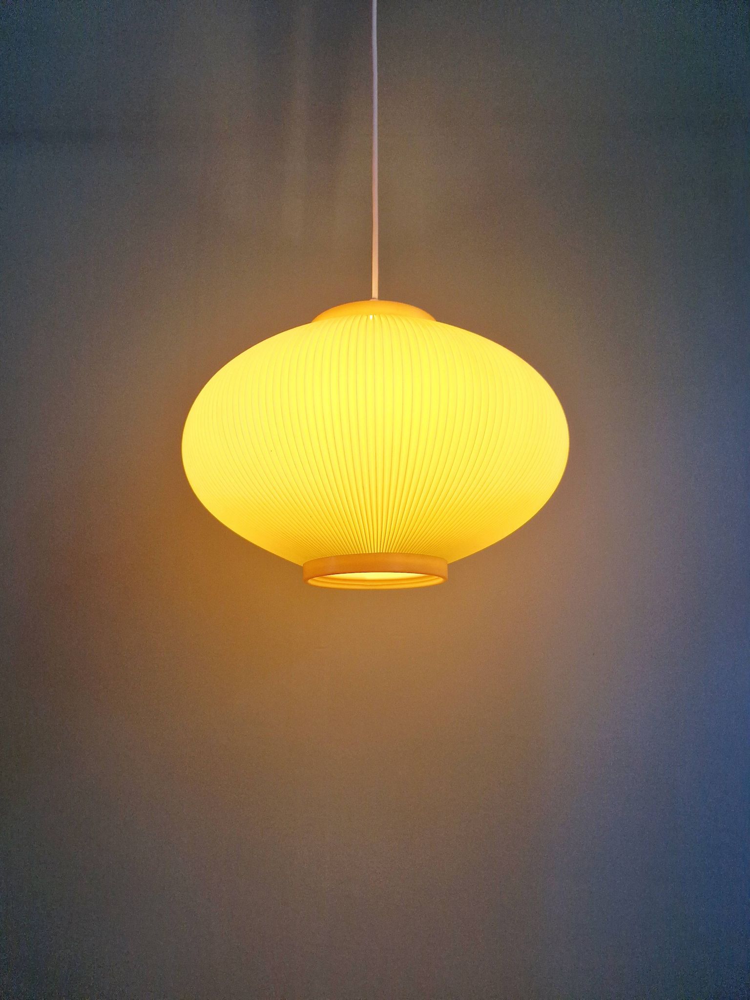 Vintage oval-shaped suspension in pleated celluloid, light green colour, 1960.