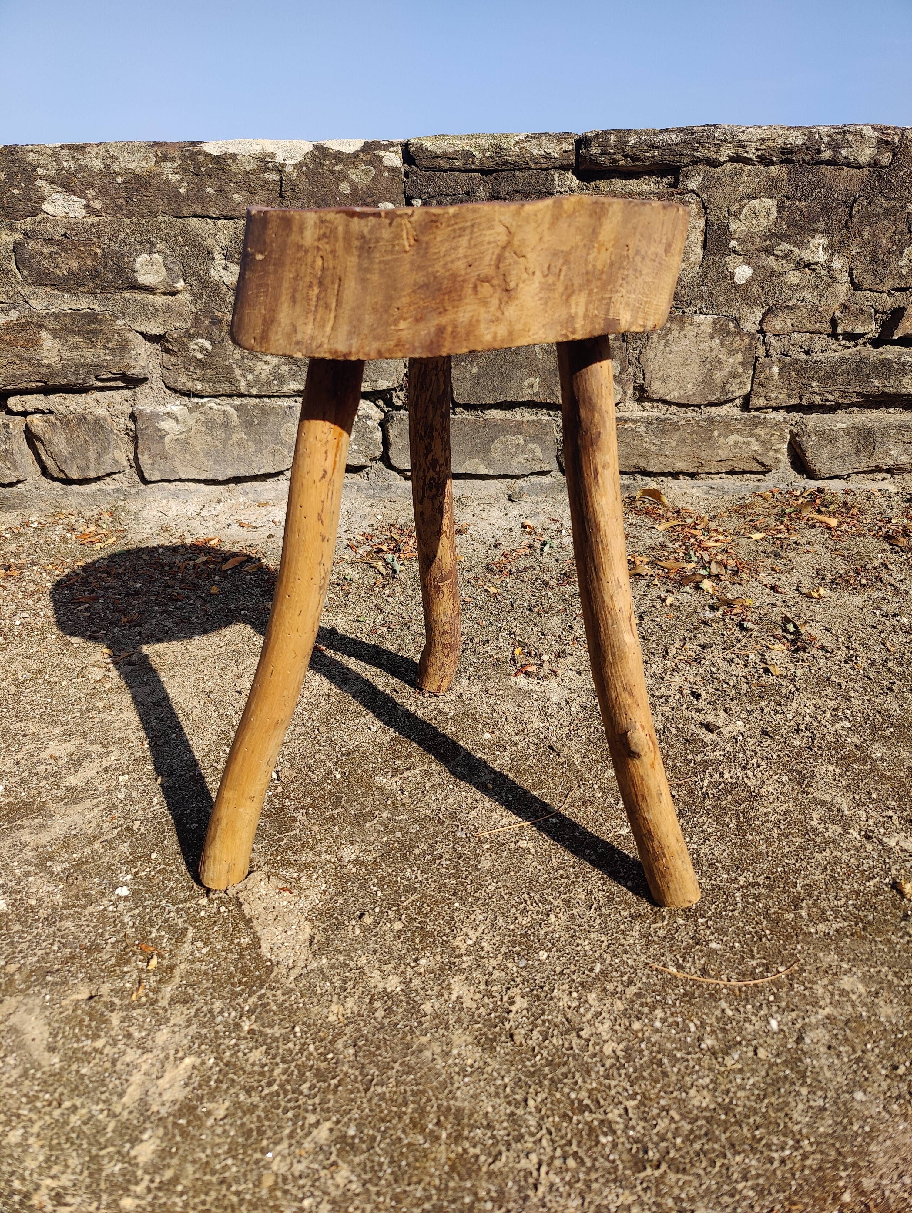 Rustic three-legged stool in minimalist wood in the style of Touret.