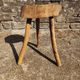 Rustic three-legged stool in minimalist wood in the style of Touret.