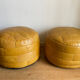 2 poufs moutarde patchwork en cuir de Sède