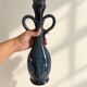 Decorative deep blue glazed ceramic vase with twin handles.
