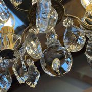 Three-light chandelier in bronze and cut crystal, early 20th century work.
