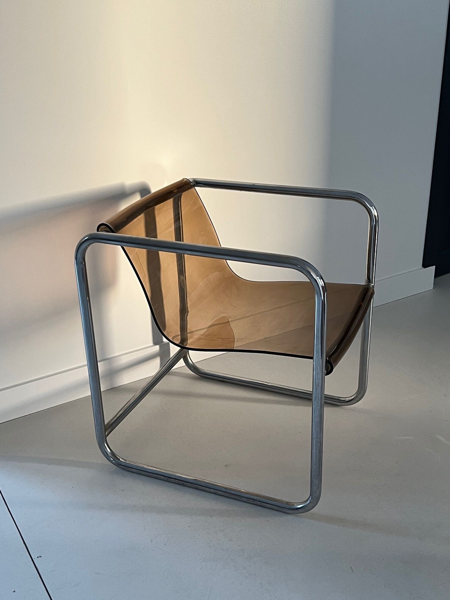 Armchair in chrome tubular metal and smoked plexiglass