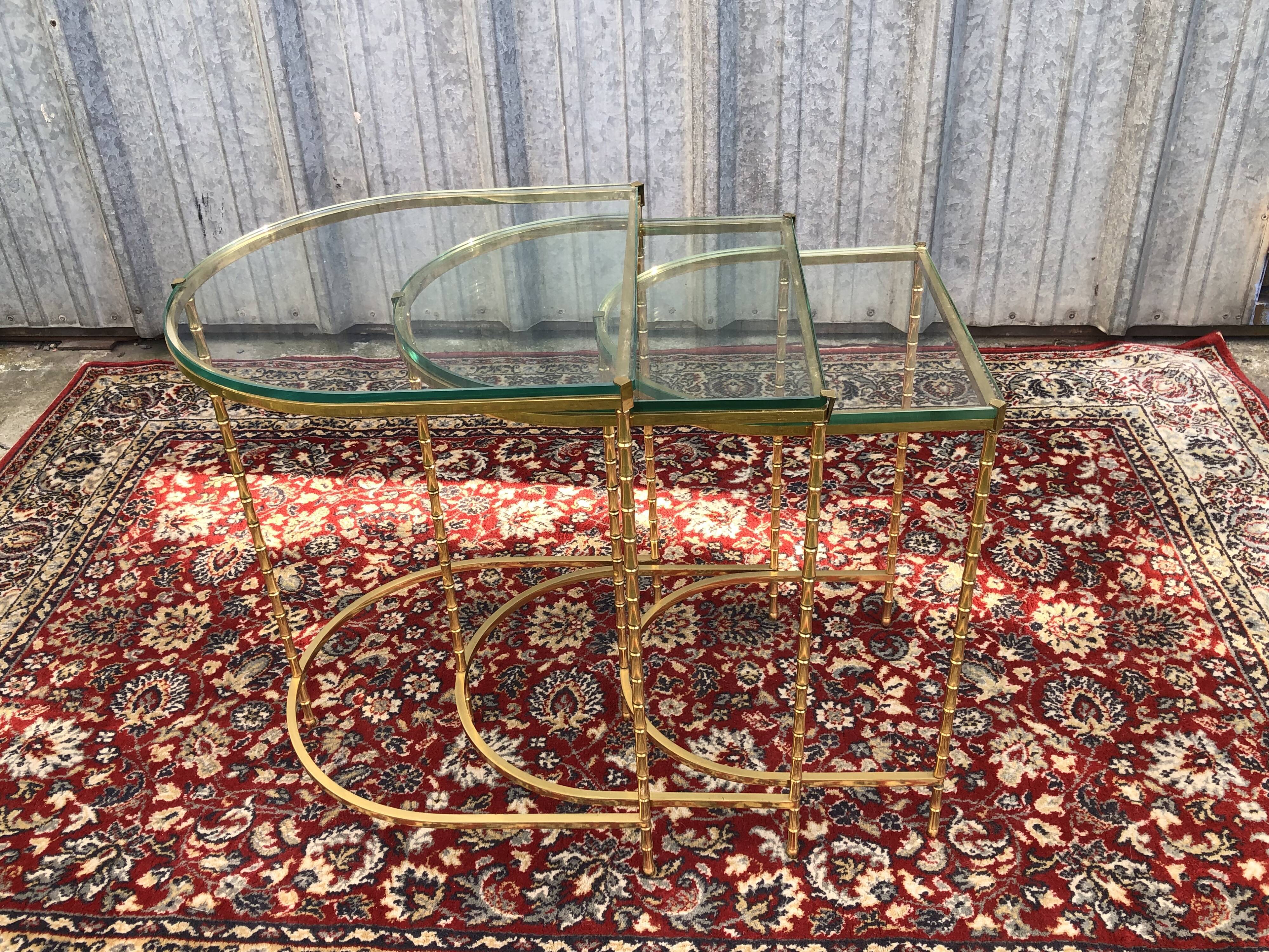 Suite of 3 trundle tables in golden brinze and glass slabs period 1970/1980
