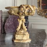 Alabaster bowl decorated with vine leaves on a base of three dolphins, circa 1880.