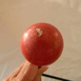 Small wrought iron coat rack with wooden balls.