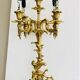 Massive gilded bronze chandeliers from the mid-20th century with marble bases.