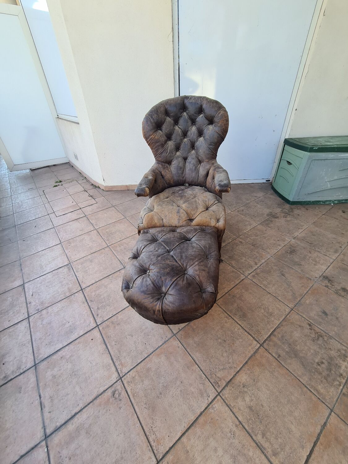 Chesterfield armchair with folding footrest