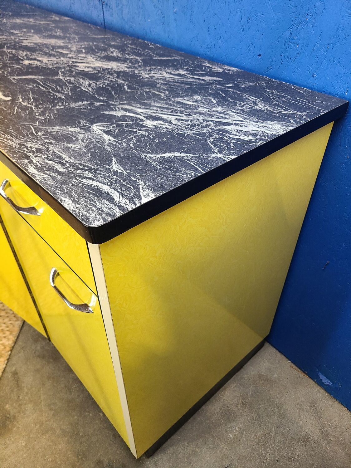 Vintage yellow sideboard, and black marble top.