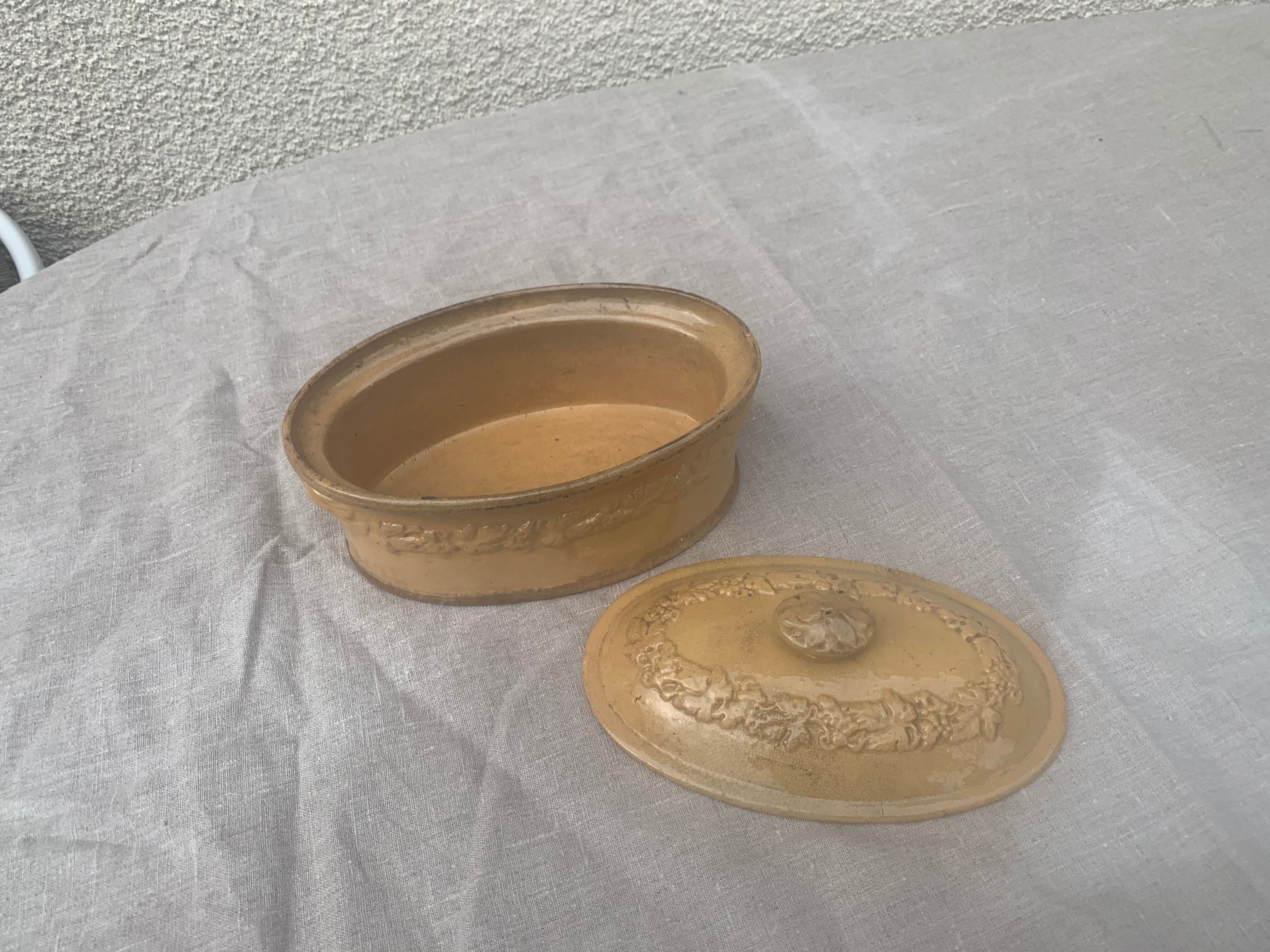 Old terrine in glazed stoneware and floral decoration mustard yellow slip