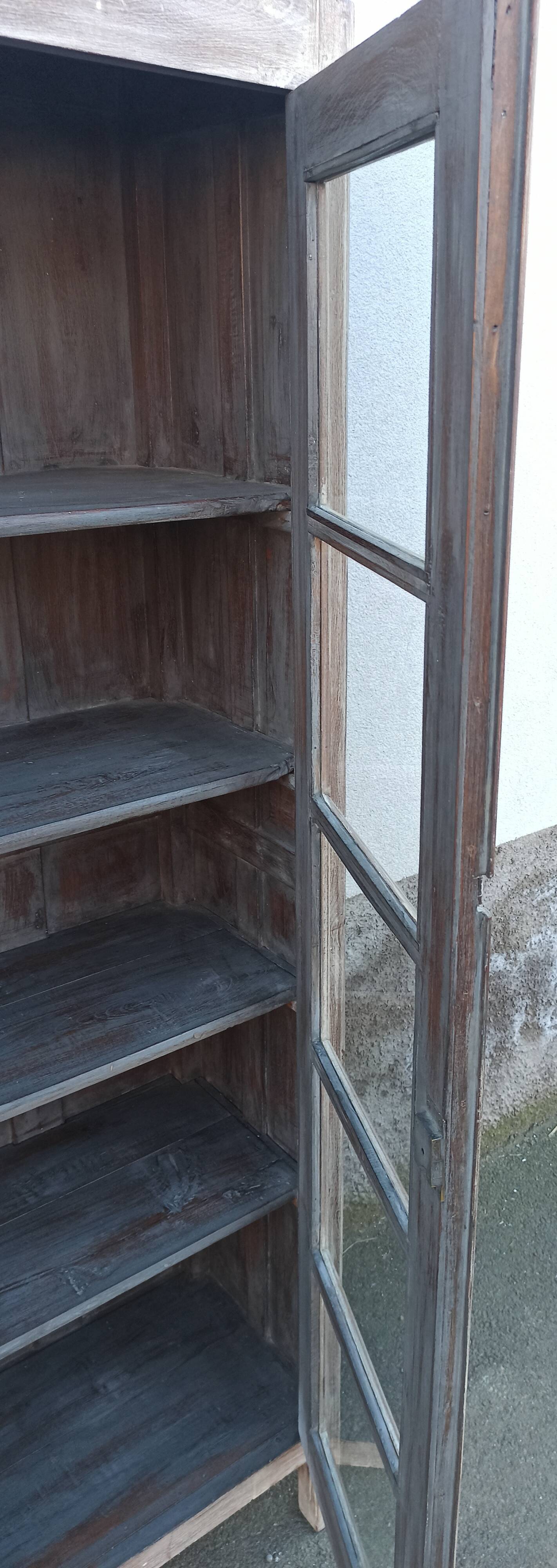 Glass cabinet in old whitewashed wood
