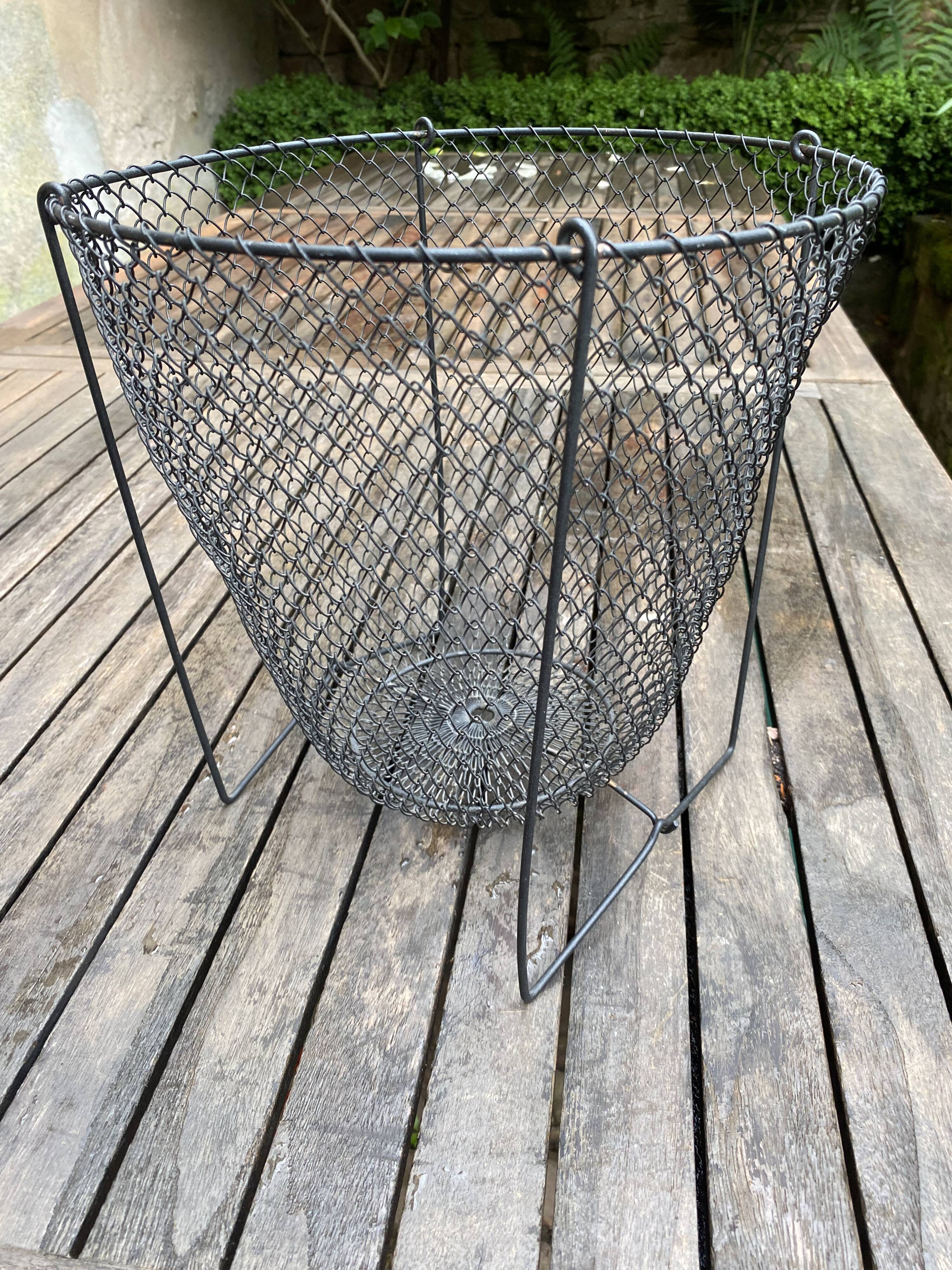 Foldable black woven metal wastepaper basket from around 1950.