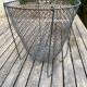 Foldable black woven metal wastepaper basket from around 1950.