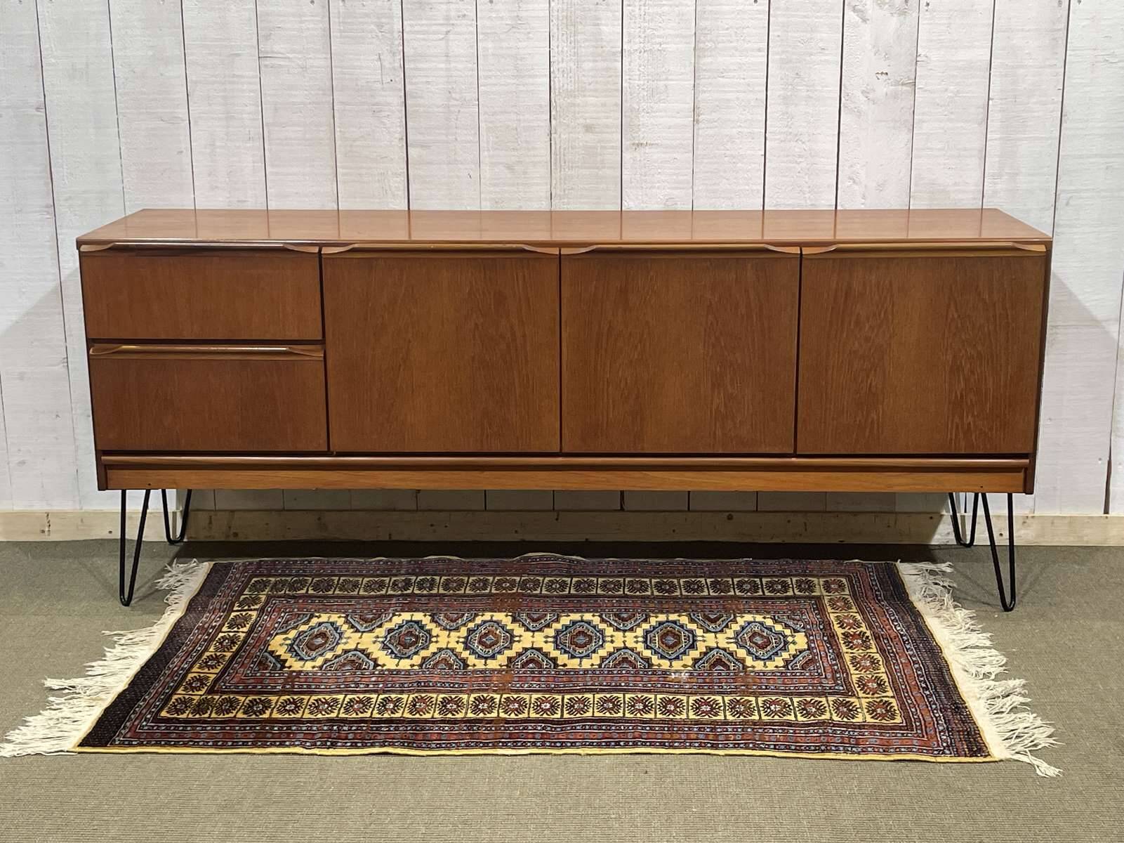 1970s English enfilade in teak with splayed legs.