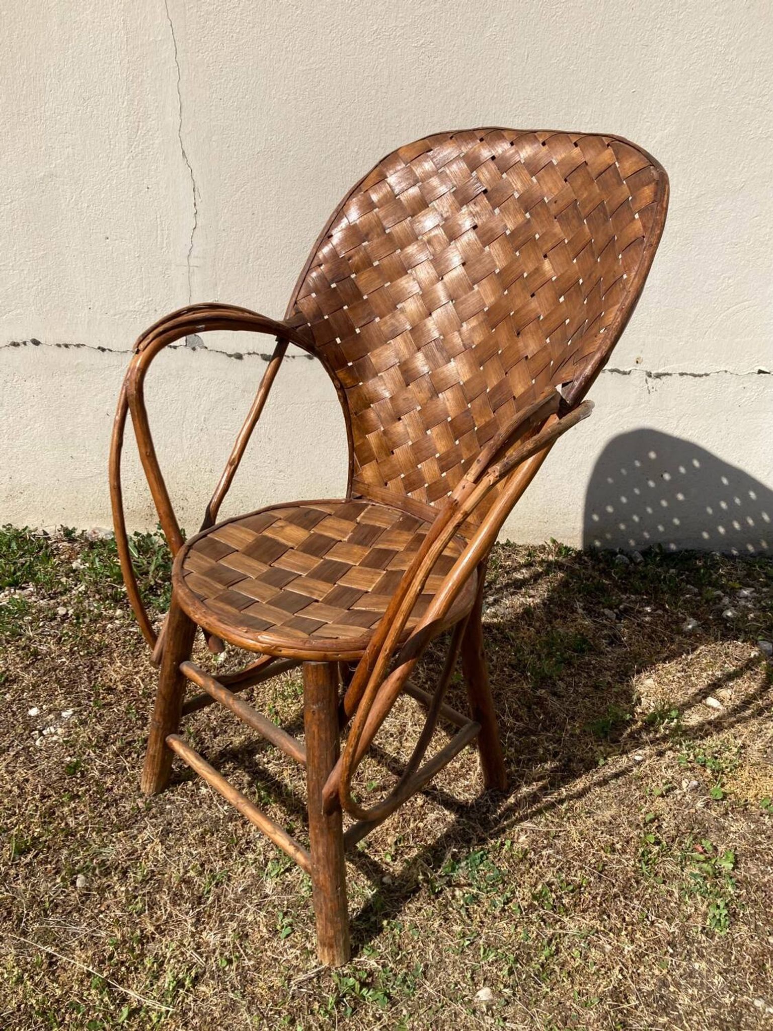 Vintage 1970s armchair in curved woven chestnut + seat cushion