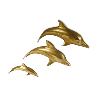 Three brass dolphins