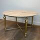 Brass coffee table with a white marble top.