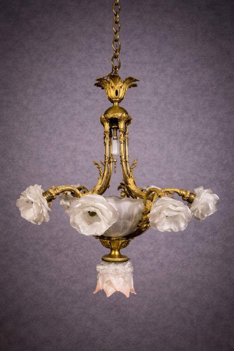 Rare and important gilded bronze chandelier with shells and roses.