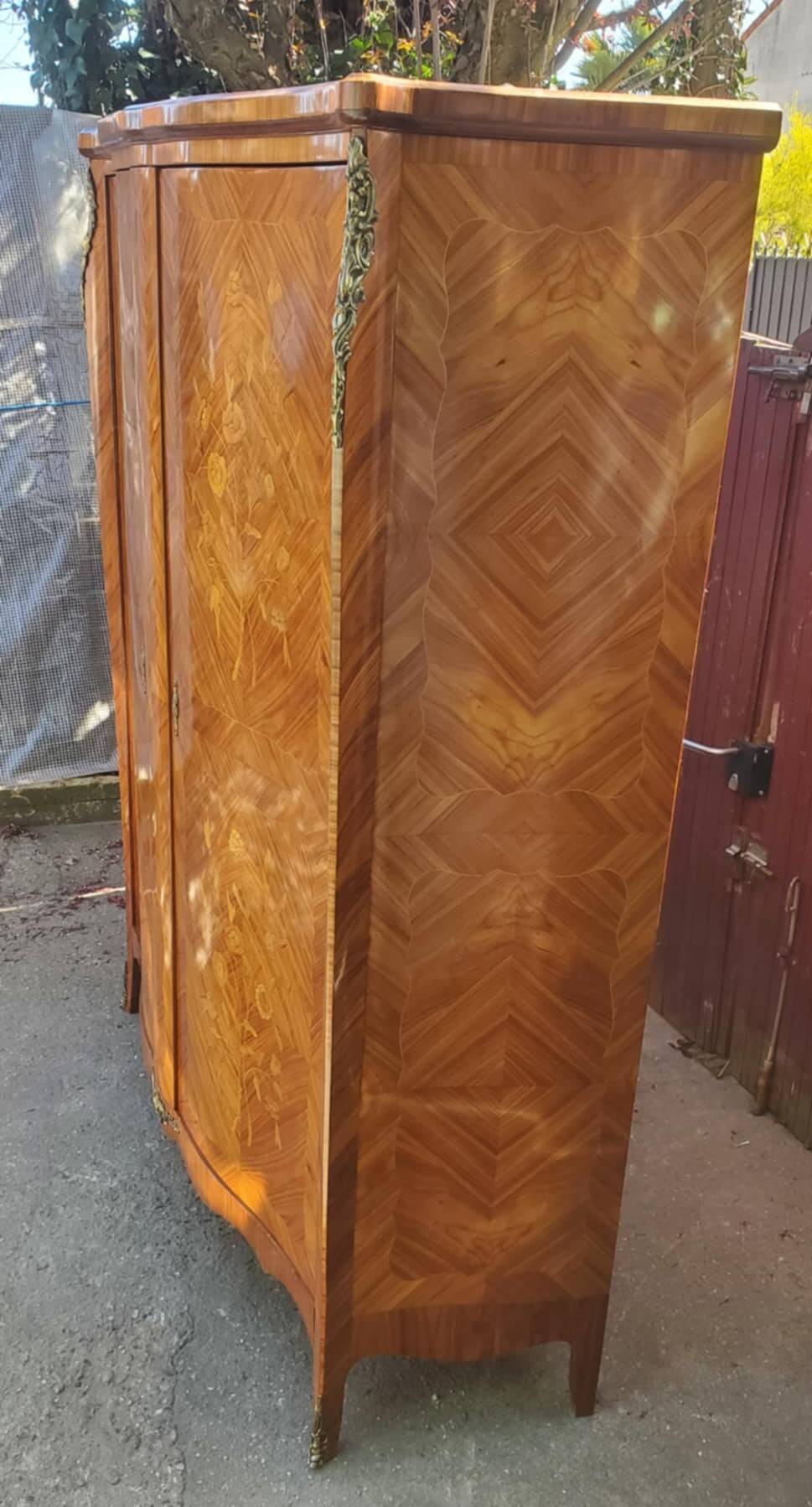 Two-door cabinet with marquetry floral design from the early 20th century.
