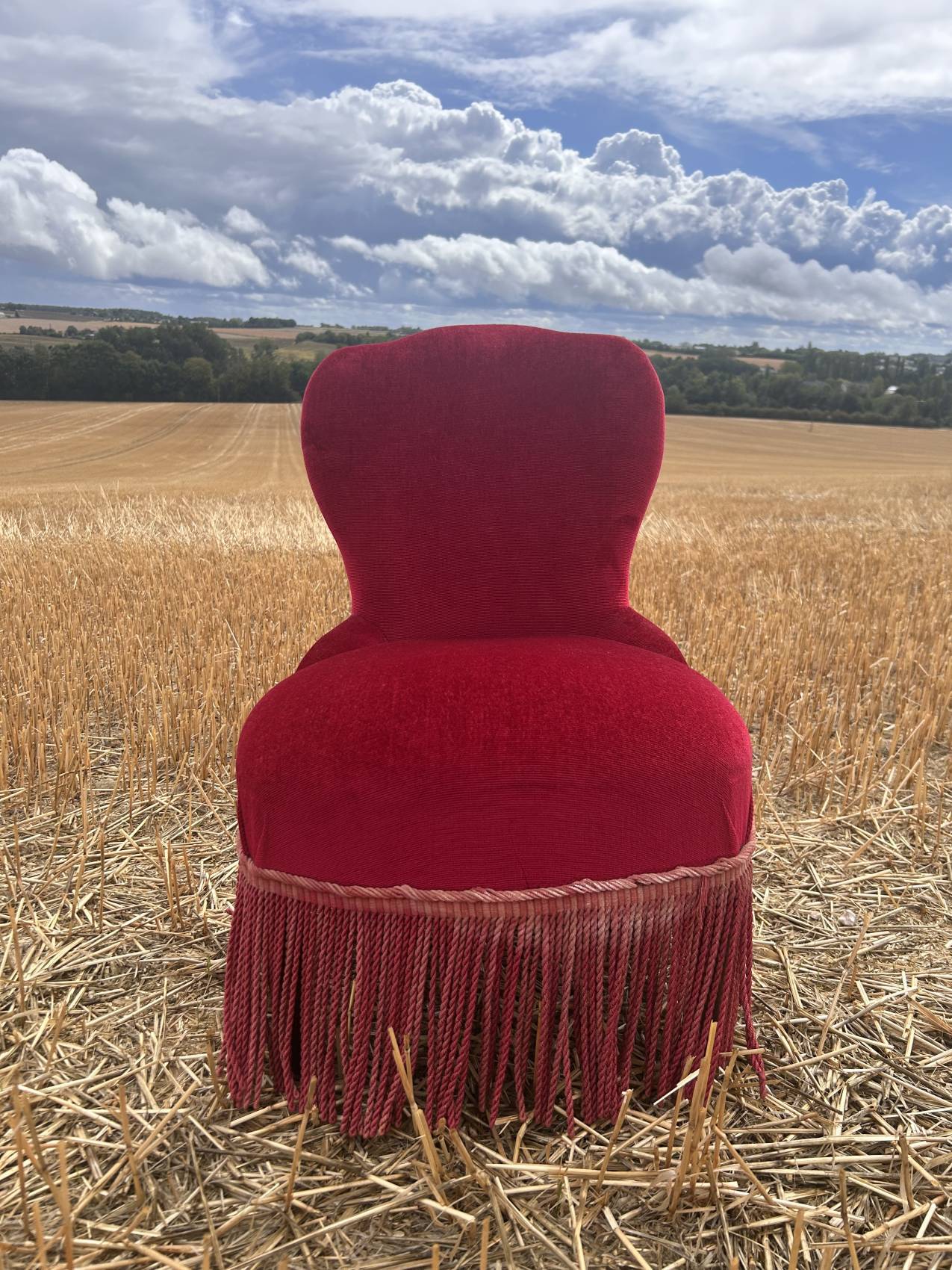 Vintage burgundy velvet armchair with fringes – theatrical and elegant