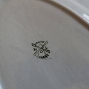 Antique oval serving dish in pale blue earthenware with a small flower design.