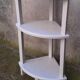Small corner shelf in wood or corner unit.