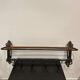 Large antique wall-mounted coat rack in wrought iron.