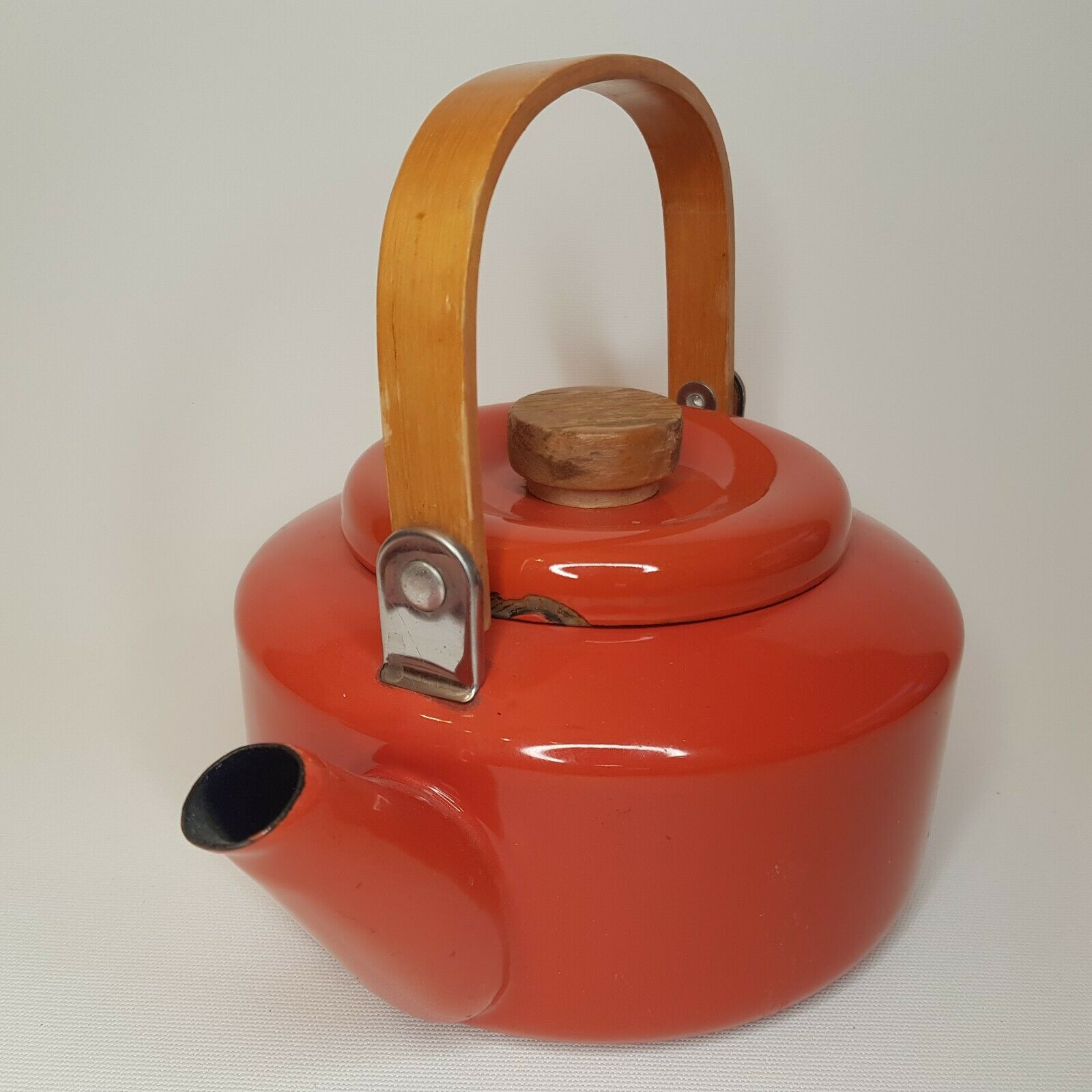 Orange and bamboo enamelled metal teapot in the 1970s