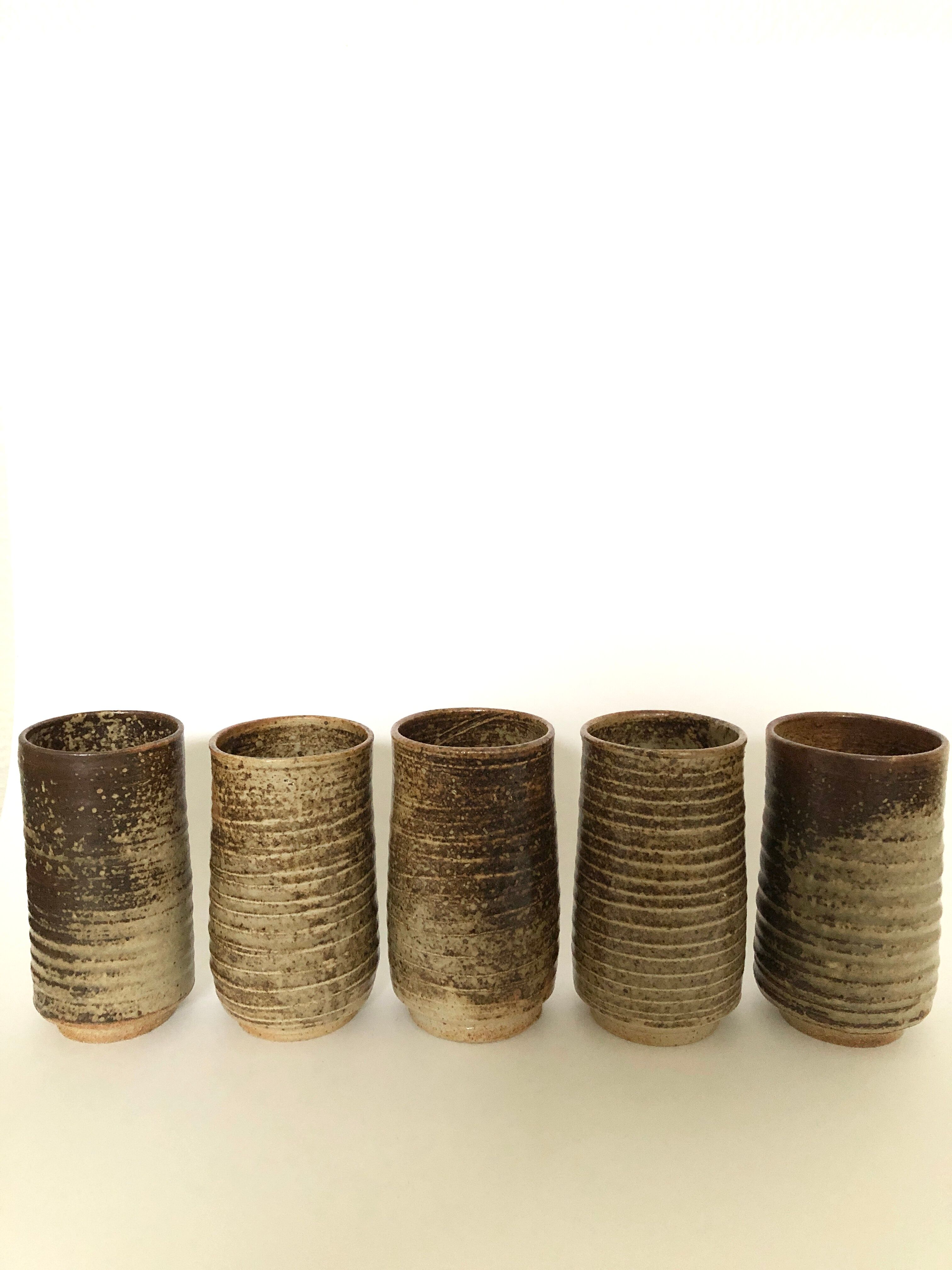 Series of five cups in sandstone