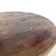 Brutalist coffee table in solid teak, monolithic slab, tripod base.