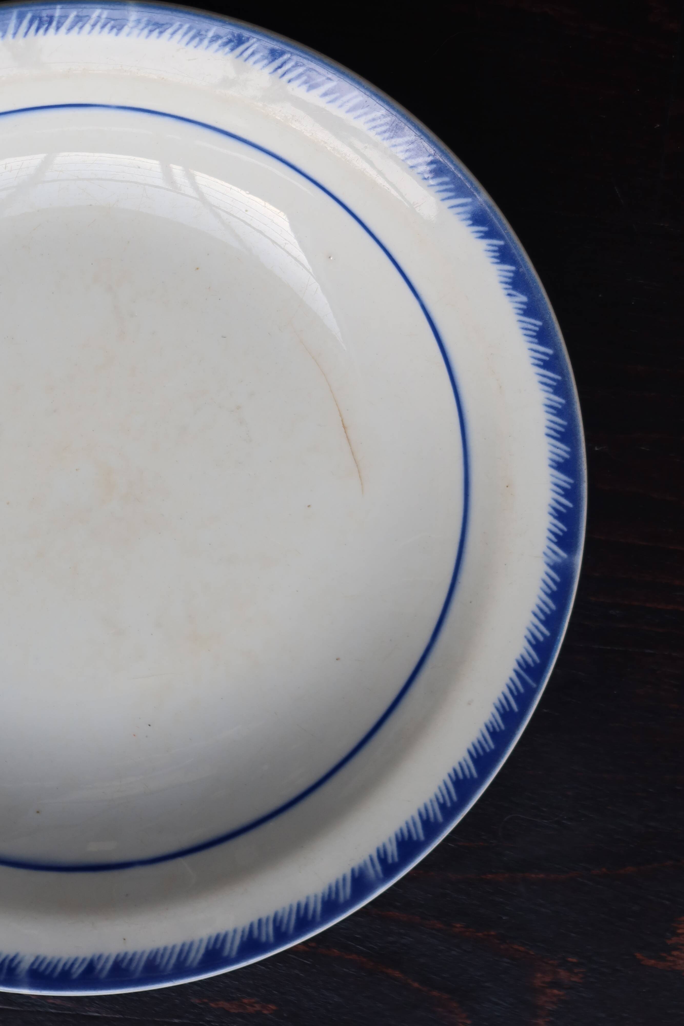 Antique shallow dish from Badonviller with blue flower decoration.