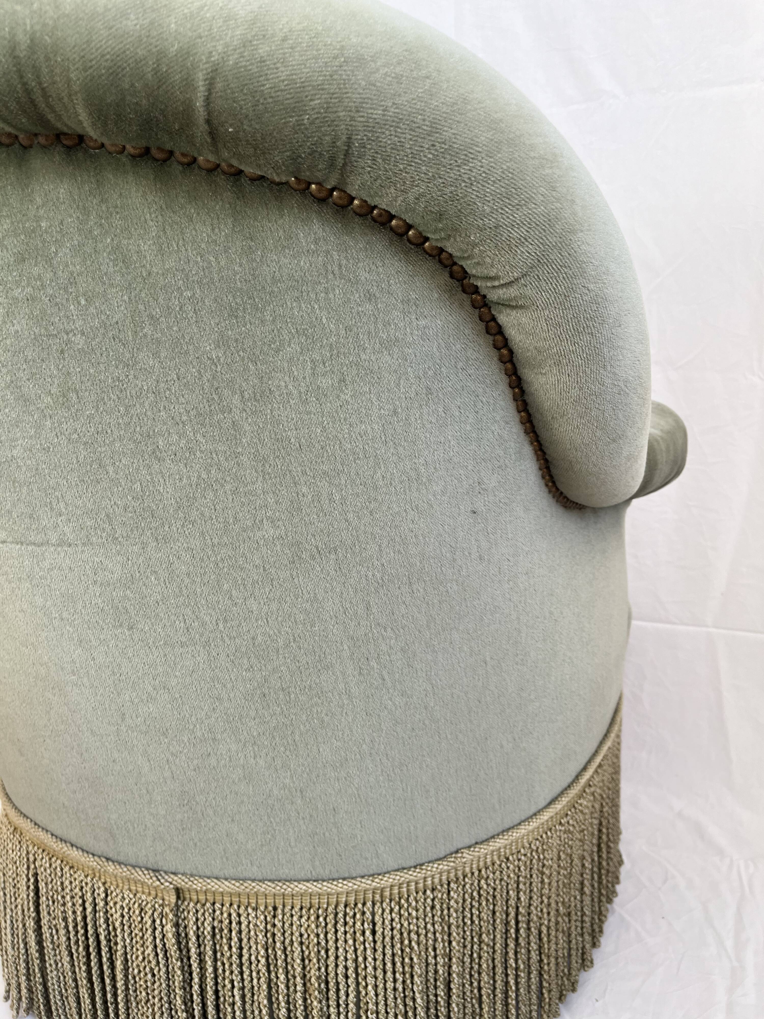 sage green toad armchairs with gold fringe