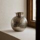 Vintage Italian vase in nickel-plated brass from the 1960s, hand-hammered relief of fruits and leaves.