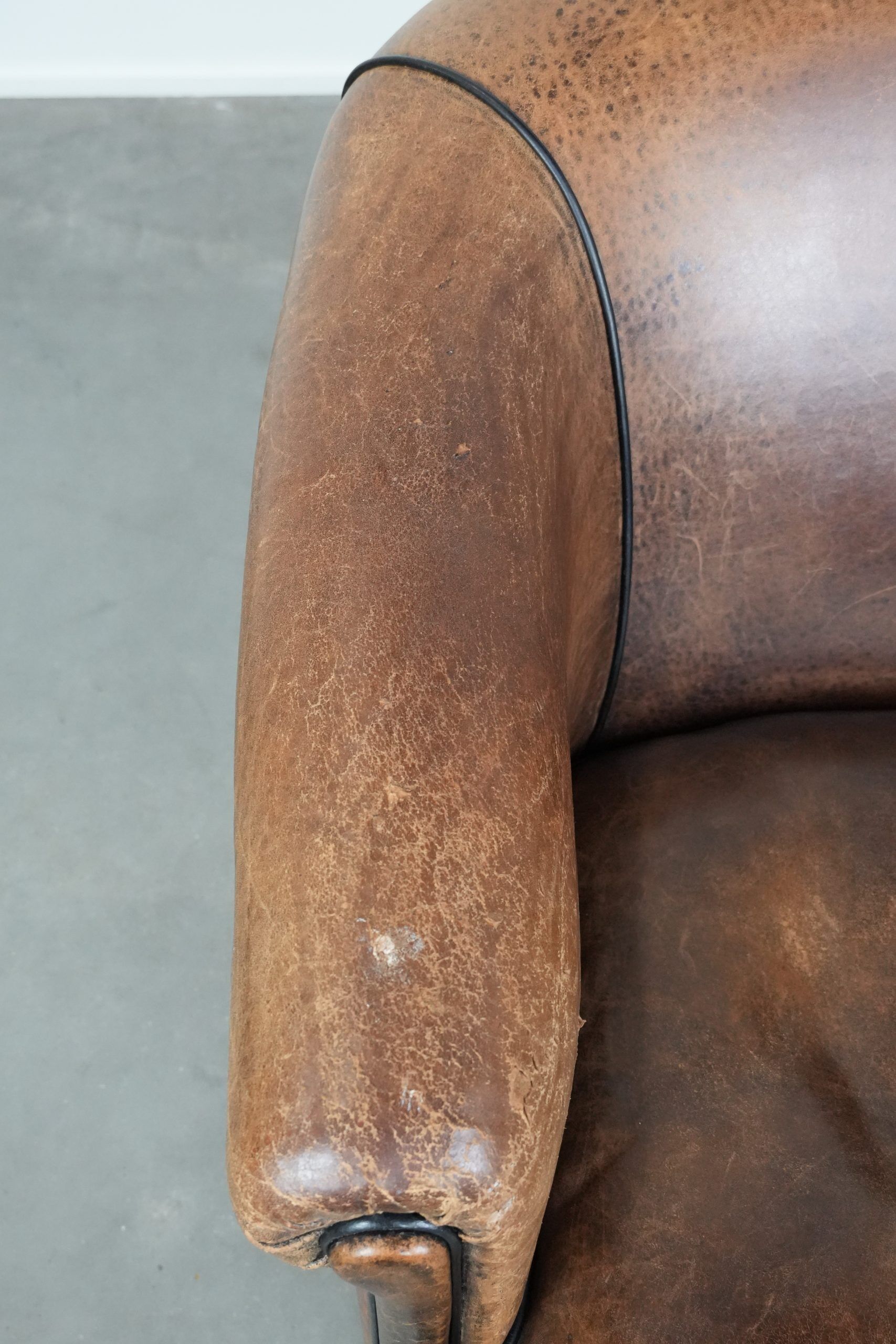 Sturdy vintage sheepskin club armchair with a beautiful patina