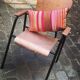 Old chair with armrest restored in metallic pink