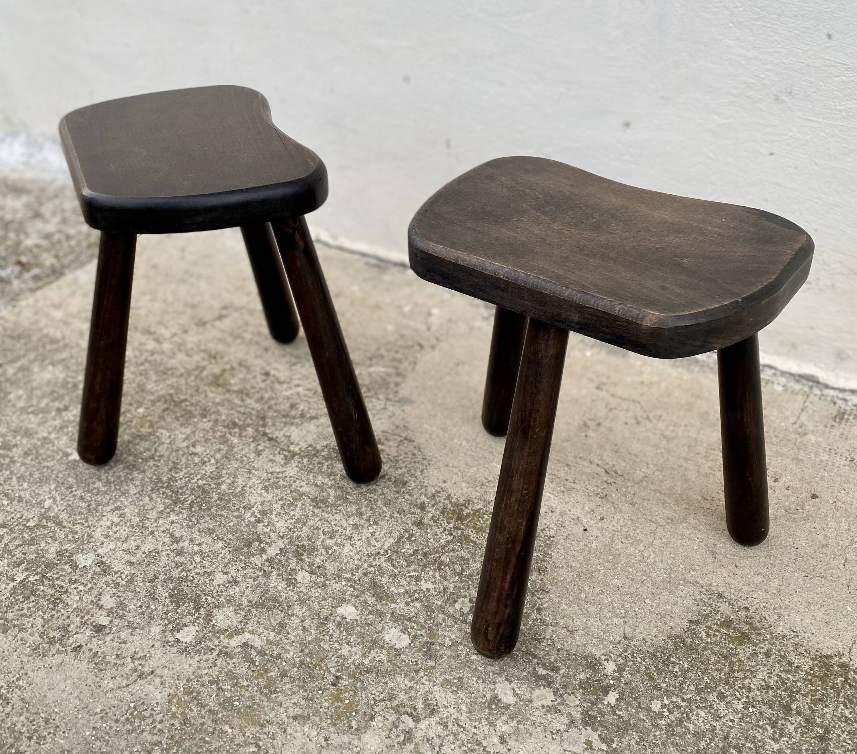 Pair of vintage stained wood tripod stools from the 1970s