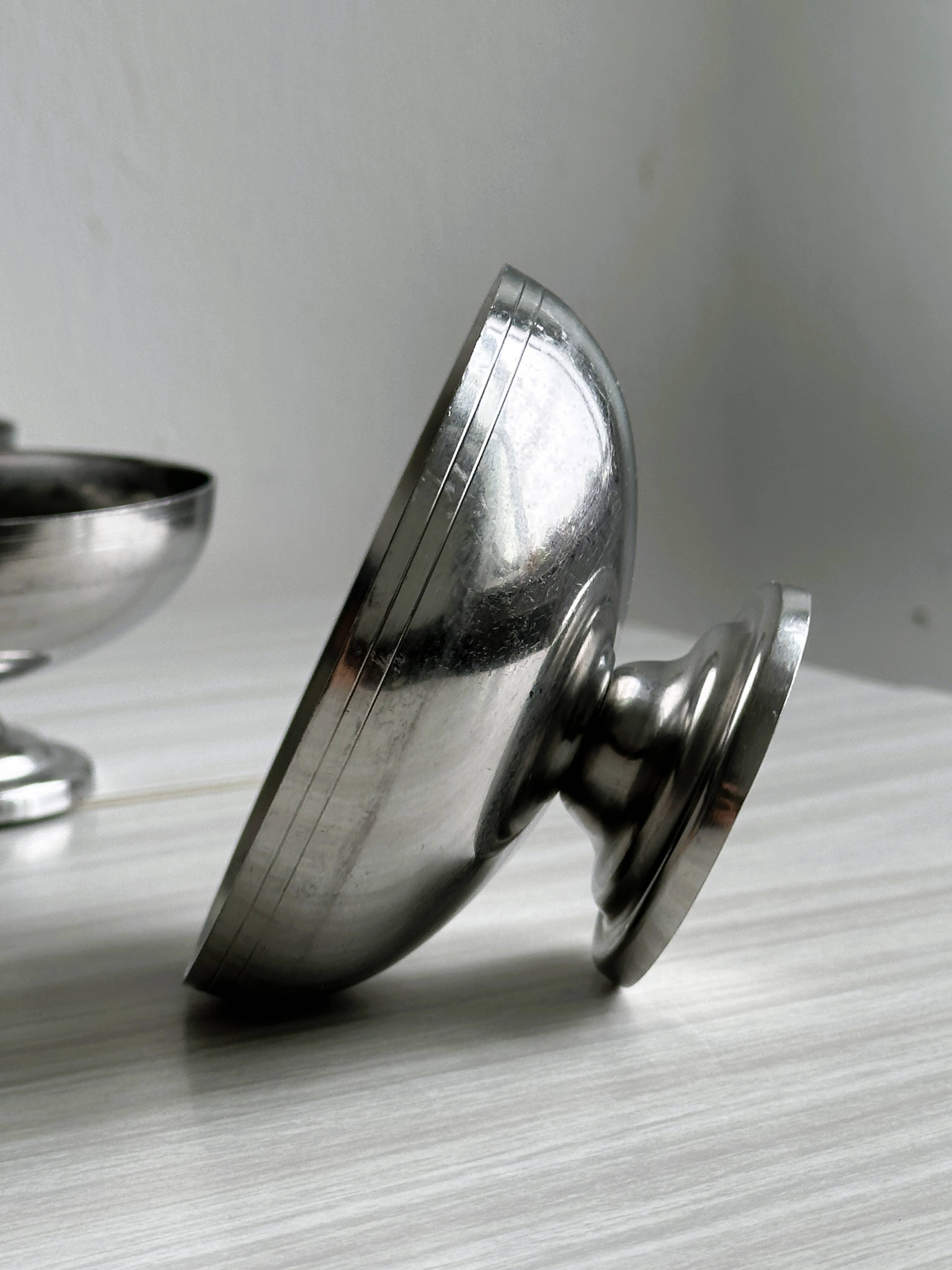 5 silver metal cups.