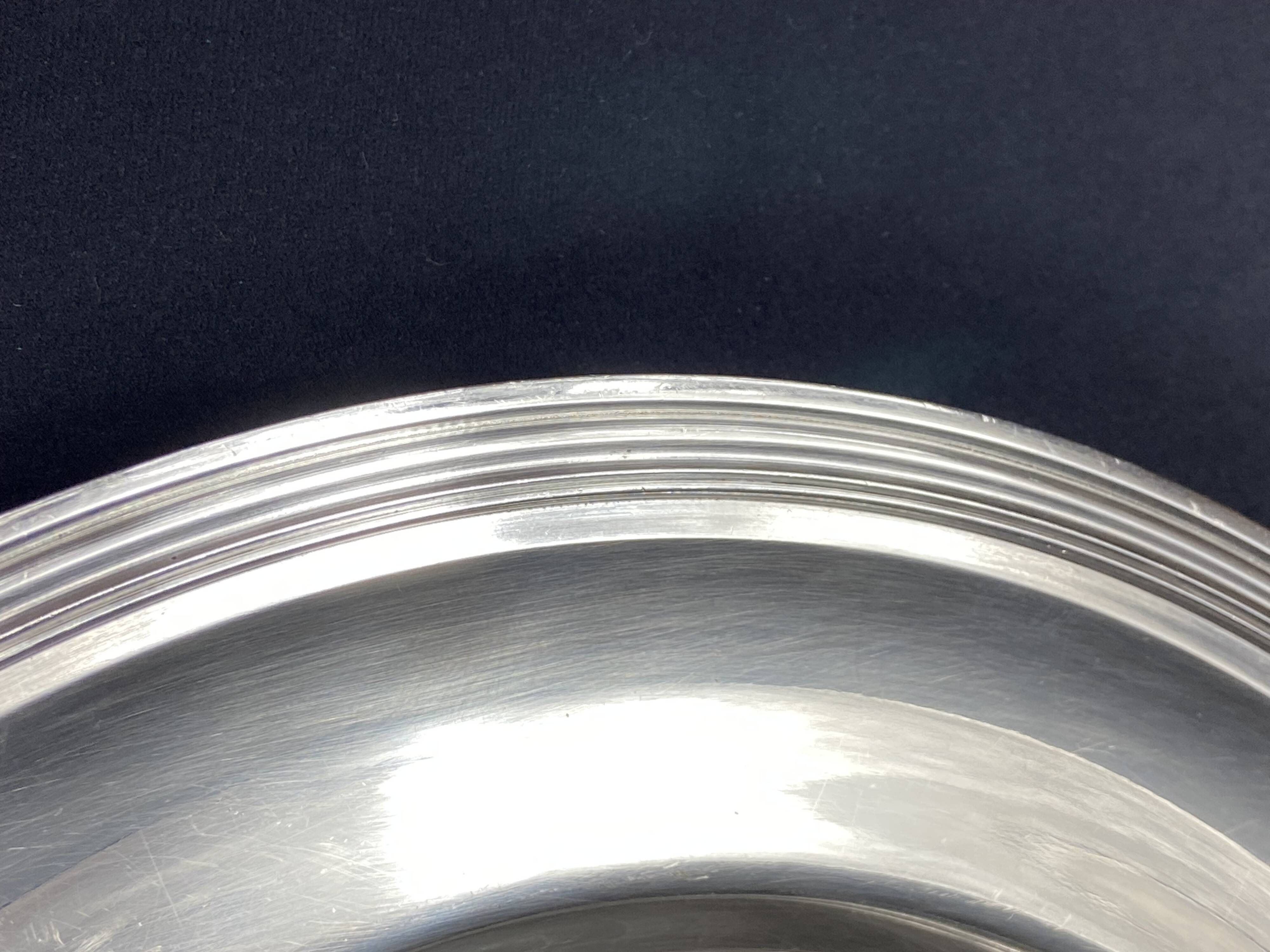 Circular silver-plated metal dish signed ercuis