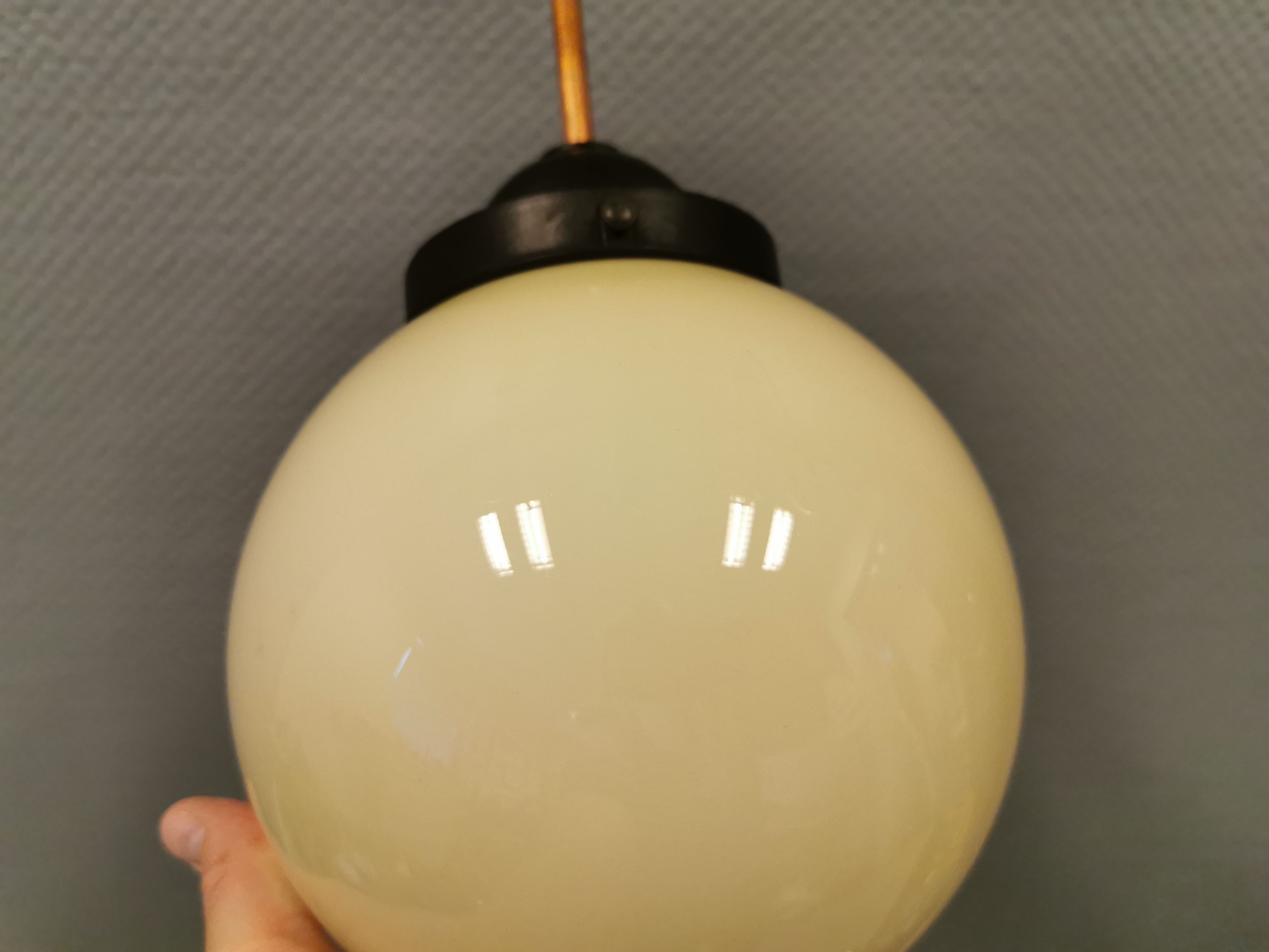 Small Art Deco hanging lamp in cream coloured glass and bakelite top.
