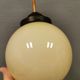 Small Art Deco hanging lamp in cream coloured glass and bakelite top.