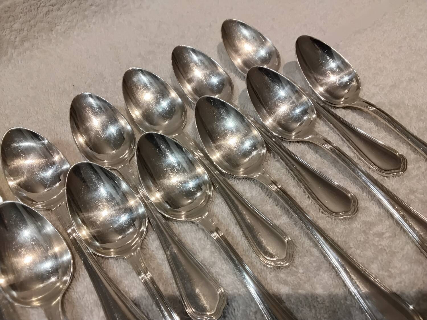 12 Christofle silver plated dessert spoons, 17cm