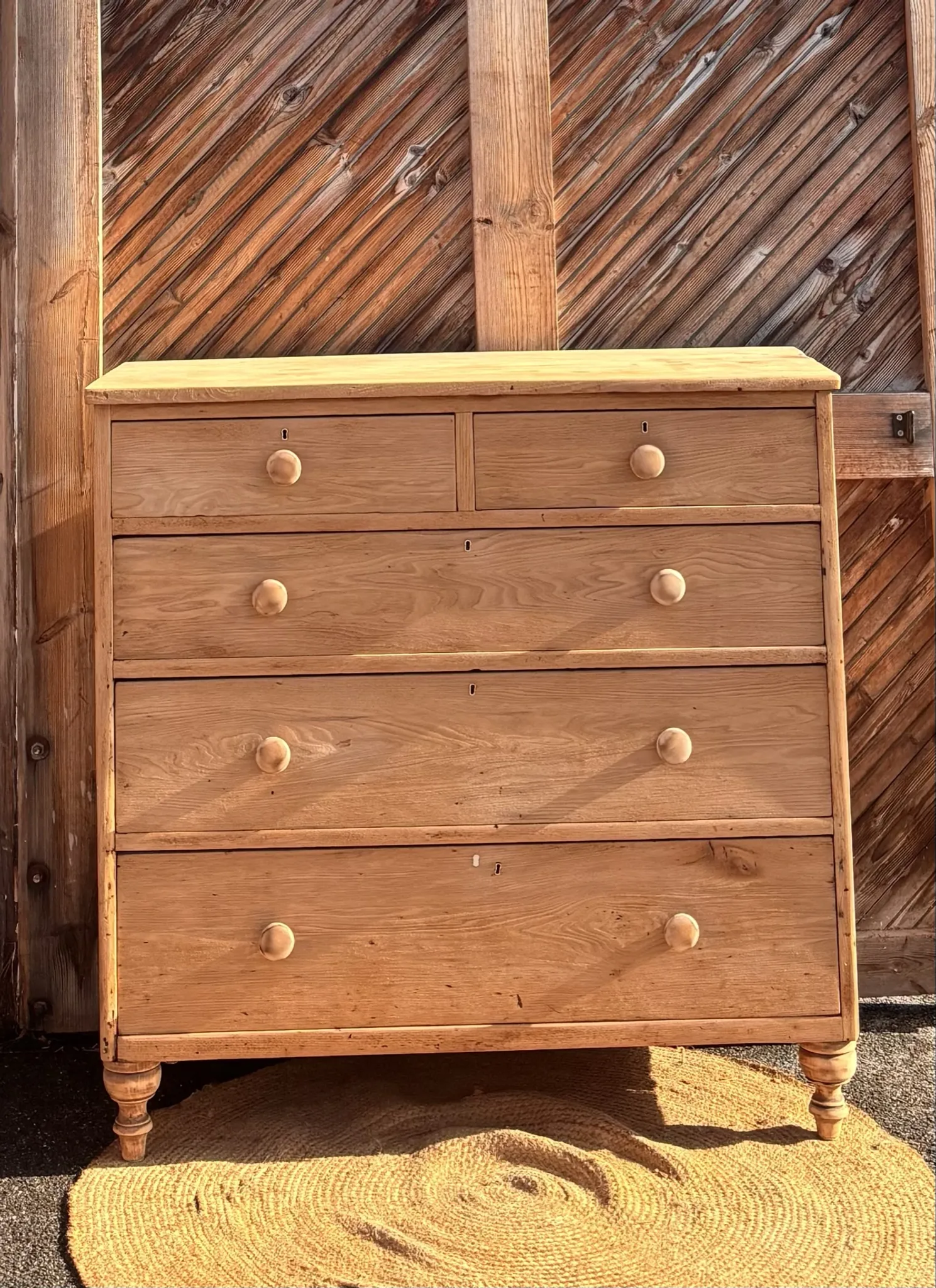 Large antique English chest of drawers in raw solid oak.